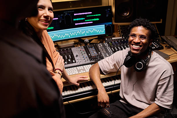 istock Young Adult Black Man Smiling While Collaborating with Colleagues in Studio 2225785840