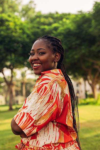 istock Smiling Woman in Bright Clothes Relaxing Outdoors near Greenery 2225786331