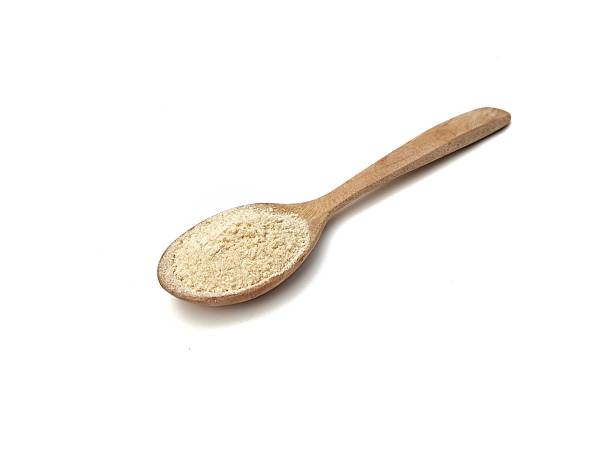 istock Ginger powder on wooden spoon isolated on white background 2225786594
