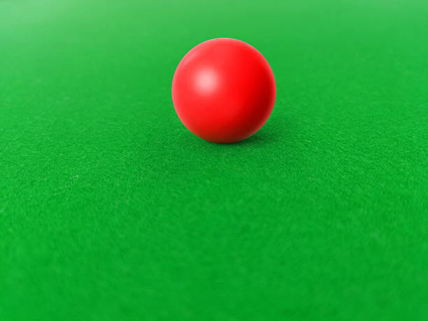 Red snooker balls on a green felt snooker table.