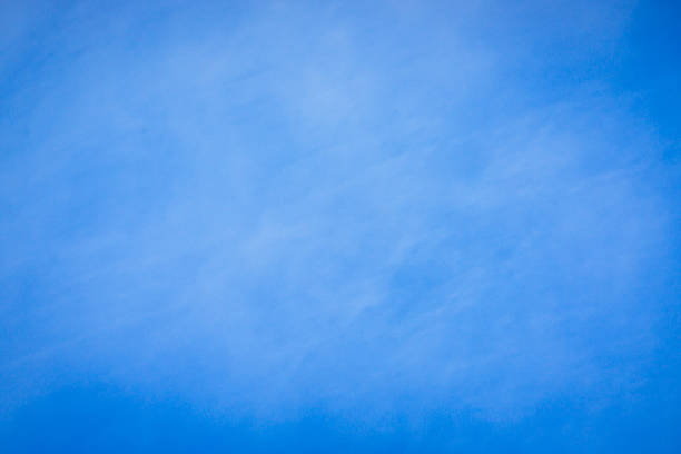 This image captures a serene and abstract view of the sky using Intentional Camera Movement (ICM). Soft blue tones and blurred clouds create a dreamy, minimalist background.