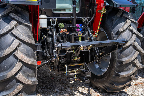 istock Agricultural tractor rear hydraulic system with coupling hoses, power take-off and linkage arms close up 2225787816