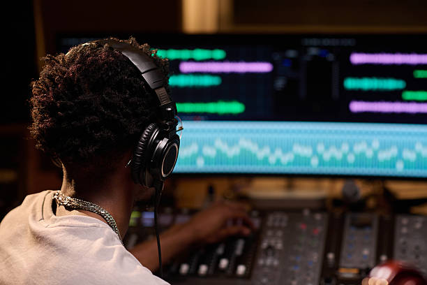 istock Young Black Man Mixing Audio Tracks in Professional Music Recording Studio 2225788086