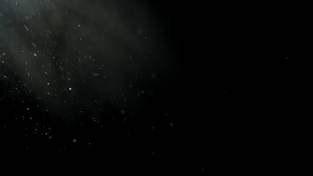 istock Floating white dust particles in light beam on black background 2225788303