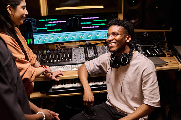 istock Young Black Man Smiling While Collaborating with Colleagues in Recording Studio 2225788435