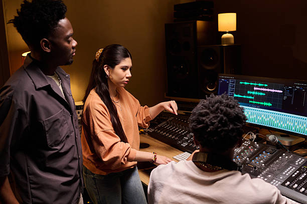 istock Young Multiethnic Music Producers Collaborating in Professional Recording Studio 2225789374