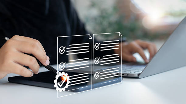 istock Hand using digital tablet with checklist and gear icons, symbolizing task management, business process automation, workflow optimization, and quality assurance system. 2225789386