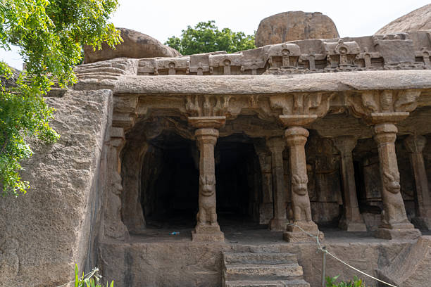 A stone building with a large archway and pillars. The archway is open and the pillars are tall. The building appears to be a temple or a church