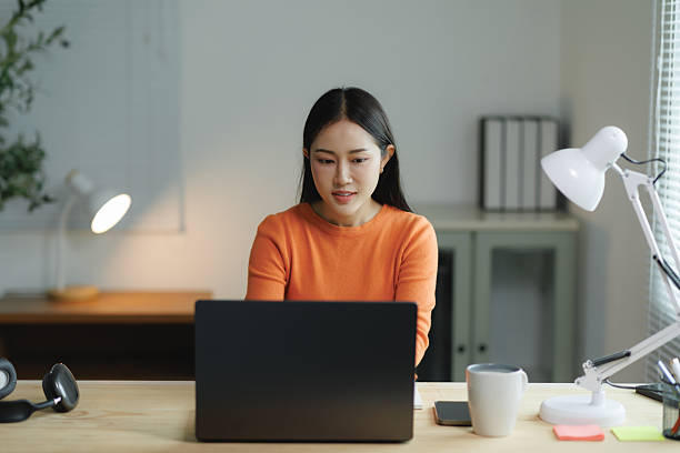 istock Young asian woman working from home office using laptop 2225790593