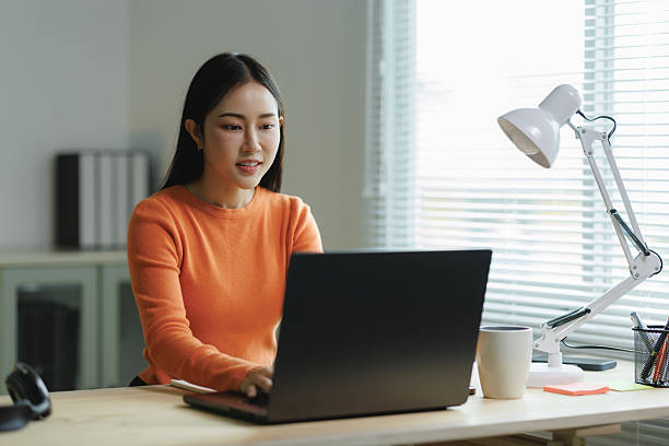 istock Young asian woman working from home on laptop 2225790594