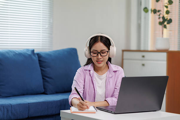 istock Young woman working from home attending online meeting taking notes 2225790785