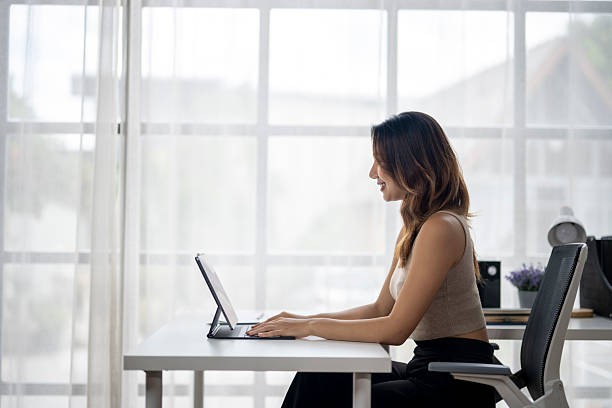 istock Young businesswoman working from home on tablet in bright office 2225793113
