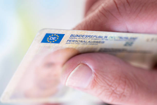istock German identity card, id document in hand, concept obtaining German citizenship, migration law, passport control border, foreign travel, obtaining visa 2225794978