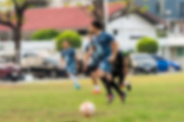Blur background professional men soccer player about to kick ball during match. Motion blur