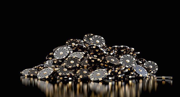 istock Black and gold poker chips forming a pile on a reflective black surface 2225797559