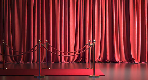 istock Red carpet and barrier in front of closed stage curtain 2225800235