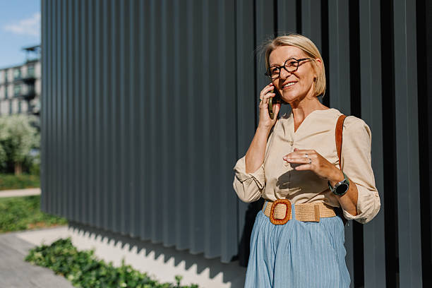 istock Stylish woman talking on a phone in sun 2225800646