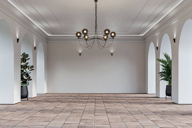 istock Modern empty interior with elegant arched openings, decorative ceiling molding, chandelier and decorative potted plants on rustic ceramic floor 2225804835