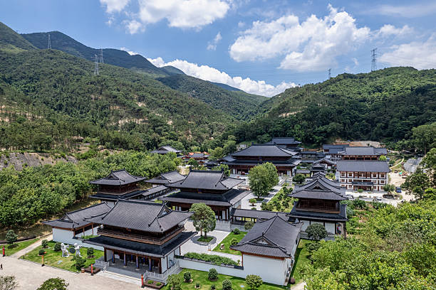 istock An aerial view shows a large classical temple in a mountain forest, with a blue sky and white clouds. 2225808062