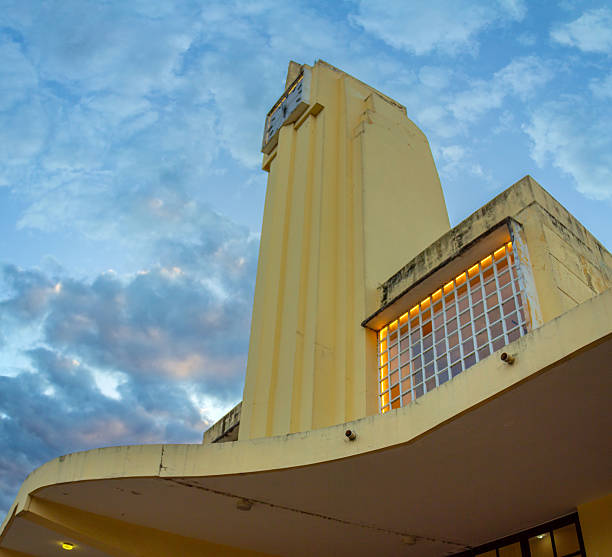 People stand in front of the landmark Tower Theater in Little Havana district of Miami, Florida, USA on cloudy day.