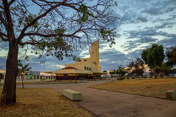 Goiania, Goias, Brazil – July 14, 2025: Panoramic view of the old Goiania City Railway Station, now the Frei Confaloni Museum, at dusk, seen through the branches of a tree.