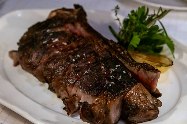 istock Medium rare meat steak on wooden plate 2225809500