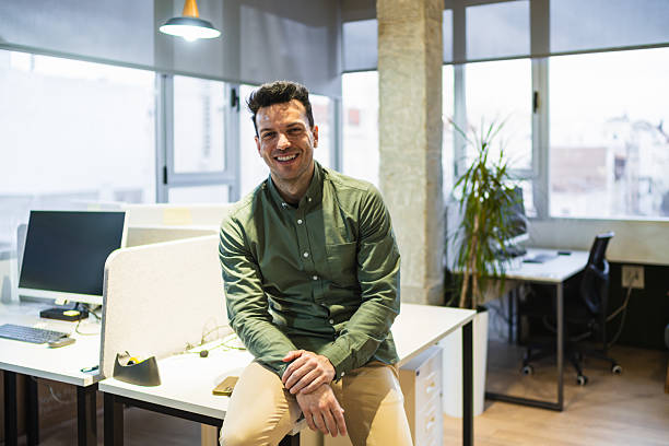 istock Young businessman smiling in the coworking office 2225811657