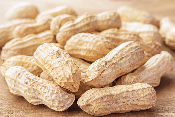 istock Closeup view of fresh peanuts on wooden table 2225812380