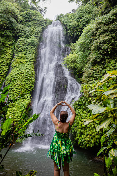 istock Woman meditating doing yoga between waterfalls 2225813070