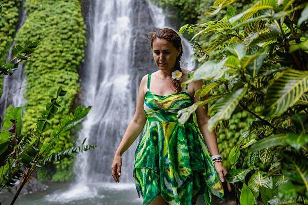 istock Woman standing near the refreshing waterfall on Bali 2225813233