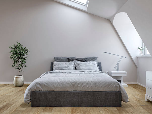 istock Front view of a modern minimalist attic bedroom with a bed, windows and decoration 2225815768