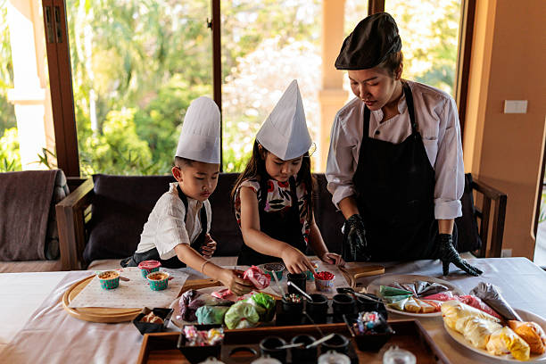 Mother and her children decorating cupcakes together