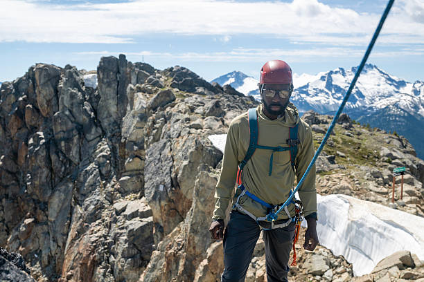 istock View down rope to climber being belayed on mountain top 2225816985
