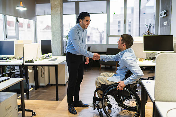istock Two businessmen shaking hands in a modern coworking office 2225817552