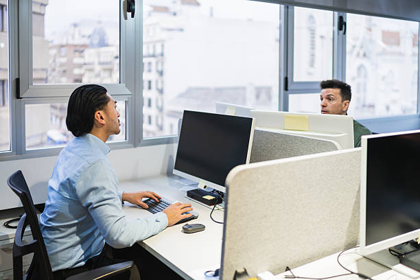 istock Young professionals working on computers in coworking office 2225818375