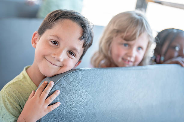 istock Smiling Children Riding a Bus Together on a Bright Sunny Day 2225818883