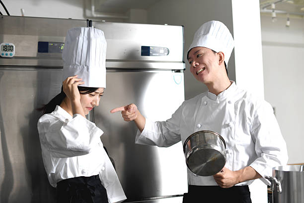 istock Asian female chef being scolded by Asian male chef in kitchen 2225822904