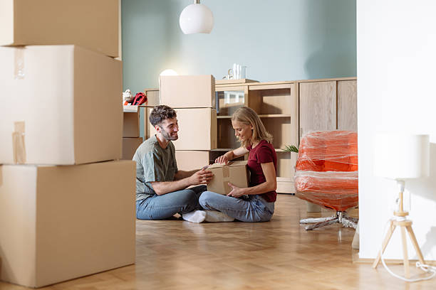 istock Young couple unpacking boxes while moving into their new apartment 2225823465