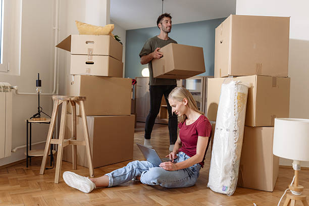 istock Young couple unpacking boxes while moving into their new home 2225823716
