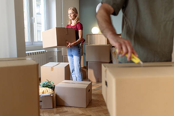 istock Young couple unpacking moving boxes in their new home 2225823796