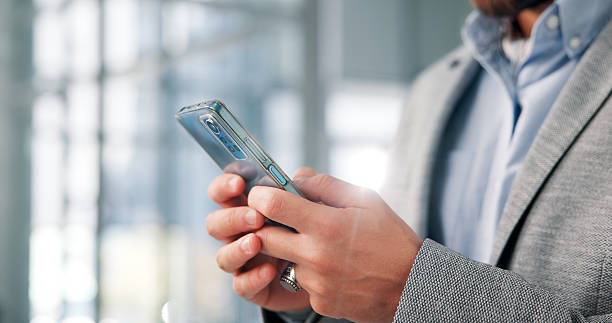 istock Hands, business and man with cellphone, connection and digital app for email, internet and website info. Closeup, person or employee in workplace, tech or economy analyst with social media or network 2225827398