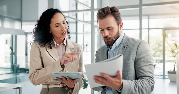 istock Office, business people and document with tablet for feedback, finance report and collaboration. Teamwork, financial advisor and manager with portfolio for investment discussion, research or solution 2225827467