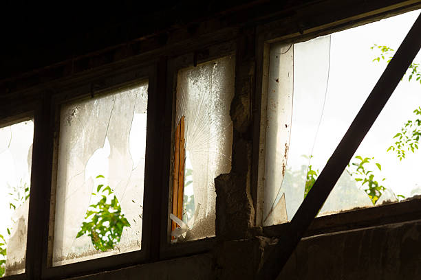 istock A long row of broken windows can be seen in a dimly lit room 2225830435