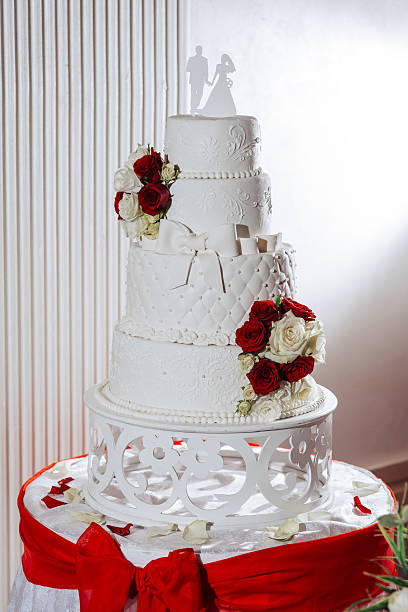 istock A four tier wedding cake with red roses and white icing 2225831425