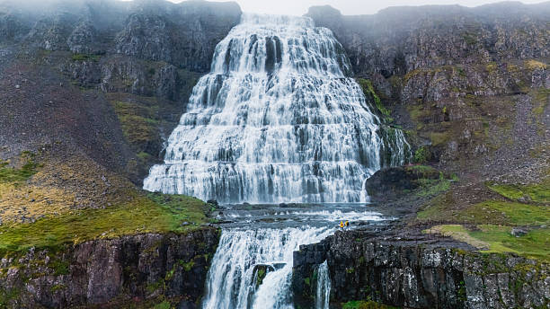 istock Majestic waterfall cascading down rocky cliffs in Icelands breathtaking landscape 2225833301