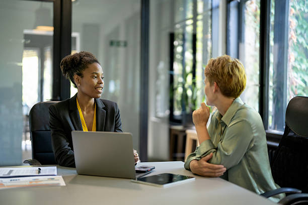 istock Two businesswomen discussing a project using laptop in modern office 2225833388