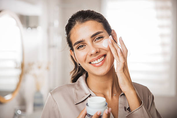 istock Young woman applying moisturizing cream 2225834689