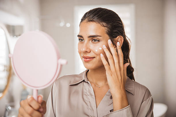 istock Young woman applying moisturizing cream 2225834693