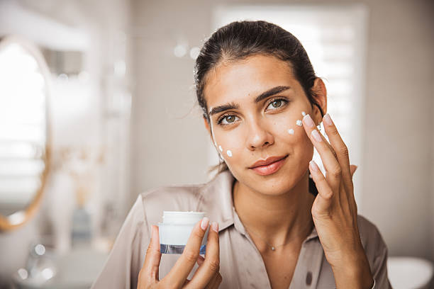 istock Young woman applying moisturizing cream 2225834698