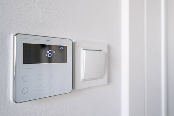 istock Sleek smart thermostat with digital display enhancing home energy efficiency 2225835808